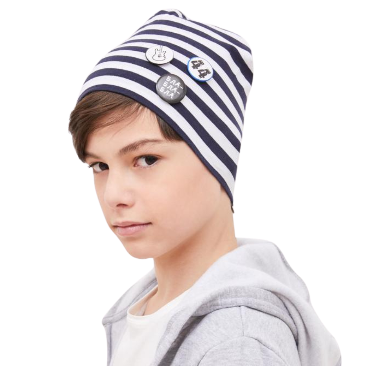 Boy wearing navy and white striped cotton beanie hat with decorative pins